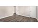 Open bedroom with hardwood-style floors, bright windows, and white trim at 5700 Tracy Dr, Mableton, GA 30126