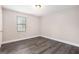 Neutral bedroom features modern light gray wood floors and bright natural light at 5700 Tracy Dr, Mableton, GA 30126