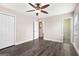 Light bedroom with hardwood-style floors, large ceiling fan, and bright window views at 5700 Tracy Dr, Mableton, GA 30126