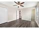 Bedroom featuring vinyl flooring, a ceiling fan, and two doors to closets and a bathroom at 5700 Tracy Dr, Mableton, GA 30126