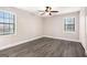 Spacious bedroom with gray wood-look floors and two bright windows at 5700 Tracy Dr, Mableton, GA 30126