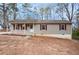 Charming ranch-style home with light siding and red shutters surrounded by trees at 5700 Tracy Dr, Mableton, GA 30126