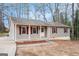 Inviting single-story home boasting vinyl siding, a covered porch, and stone landscaping accents at 5700 Tracy Dr, Mableton, GA 30126