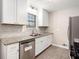Updated kitchen features stainless steel appliances, granite countertops, and white cabinets at 5700 Tracy Dr, Mableton, GA 30126