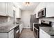 Modern kitchen with stainless steel appliances, granite countertops, and stylish tile backsplash at 5700 Tracy Dr, Mableton, GA 30126