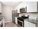 Recently renovated kitchen with stainless appliances, granite counters, and modern backsplash at 5700 Tracy Dr, Mableton, GA 30126