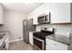 Updated kitchen featuring granite countertops, stainless steel appliances, and white shaker style cabinets at 5700 Tracy Dr, Mableton, GA 30126