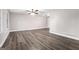 Spacious living room with modern ceiling fan, neutral paint, large windows, and durable wood-look flooring at 5700 Tracy Dr, Mableton, GA 30126