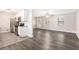 Inviting living room adjacent to kitchen boasting new floors, paint, and natural light at 5700 Tracy Dr, Mableton, GA 30126