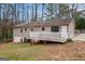 View of the home's rear, featuring a nice deck and landscaping at 5700 Tracy Dr, Mableton, GA 30126