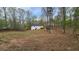 Large backyard of home with ample space, privacy trees, and back deck at 1504 Kimberly Pl, Canton, GA 30114