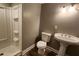 This bathroom has a toilet, a pedestal sink, and a shower at 1504 Kimberly Pl, Canton, GA 30114
