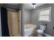 Full bathroom with a tub, shower, and toilet with grey paint and wood flooring at 1504 Kimberly Pl, Canton, GA 30114