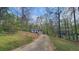 A scenic view of a two-story home surrounded by lush greenery and tall trees at 1504 Kimberly Pl, Canton, GA 30114