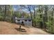 Scenic view of a two-story home with an attached garage, surrounded by lush trees at 1504 Kimberly Pl, Canton, GA 30114