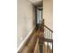 This hallway features wood flooring and a staircase with wood and iron railing at 1504 Kimberly Pl, Canton, GA 30114