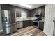 Kitchen with stainless steel appliances, granite countertops, dark wood cabinets, and bright lighting at 1504 Kimberly Pl, Canton, GA 30114