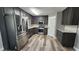 Updated kitchen features stainless steel appliances, granite countertops, and wood cabinets at 1504 Kimberly Pl, Canton, GA 30114
