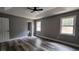 This main bedroom features wood flooring, a ceiling fan, and two windows at 1504 Kimberly Pl, Canton, GA 30114