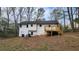 Rear of house with newly added deck, white siding, and a walk out basement entrance at 1504 Kimberly Pl, Canton, GA 30114
