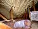 View of the attic with spray foam insulation between rafters and floor of fiberglass insulation at 2514 Green Forest Ct, Snellville, GA 30078
