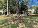 Spacious backyard with mature trees and a stone patio dining area, ideal for relaxation and entertaining at 2514 Green Forest Ct, Snellville, GA 30078