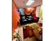 Basement media area with cozy black leather reclining love seat and red and brown tiled floor at 2514 Green Forest Ct, Snellville, GA 30078
