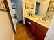 Bathroom with a vanity with wood cabinets, solid surface countertop and hardwood floors at 2514 Green Forest Ct, Snellville, GA 30078
