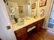 Bathroom featuring a vanity with wood cabinets, solid surface countertop and hardwood floors at 2514 Green Forest Ct, Snellville, GA 30078