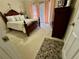 Carpeted bedroom with a wooden bed frame, side table, armoire and a window with curtains at 2514 Green Forest Ct, Snellville, GA 30078
