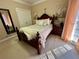 Bedroom with a dark wood bed frame, neutral color scheme and carpeted floor; lots of natural light and closet at 2514 Green Forest Ct, Snellville, GA 30078
