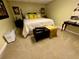 A charming bedroom features a comfortable queen-size bed, soft carpet, and ample natural light at 2514 Green Forest Ct, Snellville, GA 30078