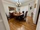 Formal dining room featuring elegant wood table, chandelier lighting, and hardwood flooring at 2514 Green Forest Ct, Snellville, GA 30078