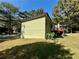 Exterior of the house showcasing the side yard, red deck, and mature trees at 2514 Green Forest Ct, Snellville, GA 30078