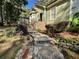 Stone pathway leading to a charming home entrance with manicured landscaping at 2514 Green Forest Ct, Snellville, GA 30078