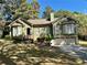 Charming home with lush landscaping, bay windows, and an attached two-car garage at 2514 Green Forest Ct, Snellville, GA 30078