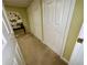 Hallway features 3 doors and neutral-toned walls and flooring, providing a serene and inviting atmosphere at 2514 Green Forest Ct, Snellville, GA 30078