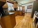 Traditional kitchen features wood cabinets, granite countertops, hardwood floors and stainless steel appliances at 2514 Green Forest Ct, Snellville, GA 30078
