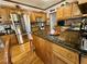 Eat-in kitchen offers wood cabinets, stainless steel appliances and granite countertops at 2514 Green Forest Ct, Snellville, GA 30078