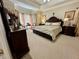 Primary bedroom features a trey ceiling, carpet, large windows, and decorative furnishings at 2514 Green Forest Ct, Snellville, GA 30078