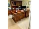 A home office with a large wood desk, shelves and a hutch offers a great work environment at 2514 Green Forest Ct, Snellville, GA 30078