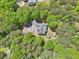 Overhead view of house with gray roof and circular driveway surrounded by trees and a separate small building at 270 Morrow Rd, Newborn, GA 30056