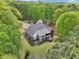 Stunning aerial view of brick home surrounded by lush greenery, showcasing the expansive property and serene setting at 270 Morrow Rd, Newborn, GA 30056