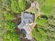 Aerial view of a gray roofed house nestled among green trees with a circular driveway and a separate building at 270 Morrow Rd, Newborn, GA 30056