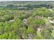 Aerial view of a house surrounded by green trees, showcasing a sprawling landscape with a pool in the distance at 270 Morrow Rd, Newborn, GA 30056