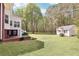 Expansive backyard with a shed surrounded by lush greenery, offering serene outdoor living and recreational possibilities at 270 Morrow Rd, Newborn, GA 30056