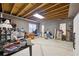 Unfinished basement with concrete floors, exposed wooden ceiling and walls with tools and shelving at 270 Morrow Rd, Newborn, GA 30056