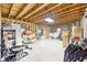 Unfinished basement with concrete floor, exposed ceiling beams, furniture and personal items and under-construction walls at 270 Morrow Rd, Newborn, GA 30056