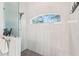 Bright bathroom shower with modern tiled walls, a rain shower head, glass partition, and a window with a view at 270 Morrow Rd, Newborn, GA 30056