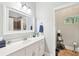 Clean bathroom with a large mirror, white vanity, and tile flooring at 270 Morrow Rd, Newborn, GA 30056
